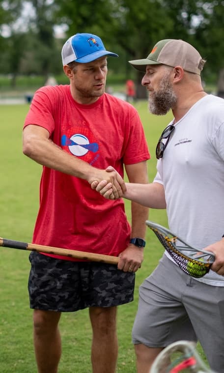 Patrick Chapla shaking hands with a coach on the field